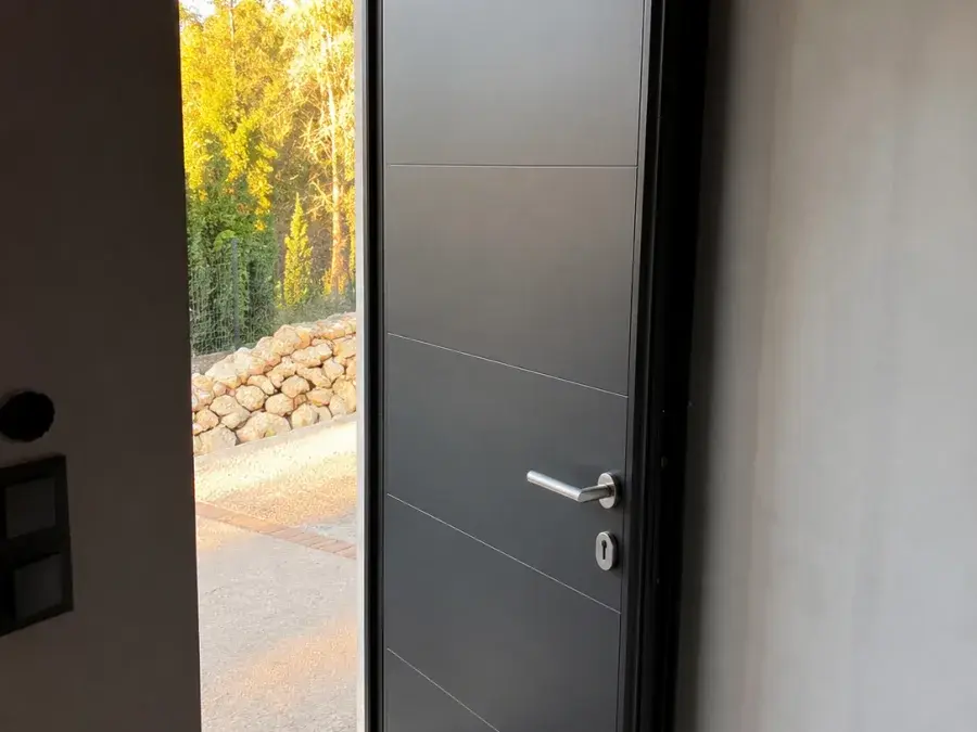 Antracit Aluminijumska vrata otvorena u hodniku, vidi se masivno krilo